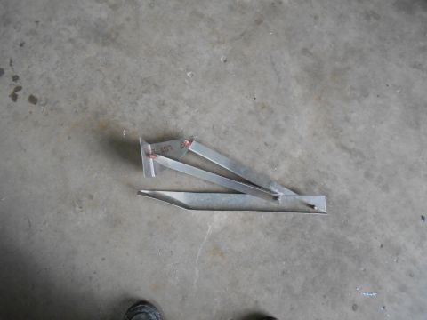 1992 Ford Bronco - A metal bracket with 'LOT 207' stamped on it rests on a concrete surface.