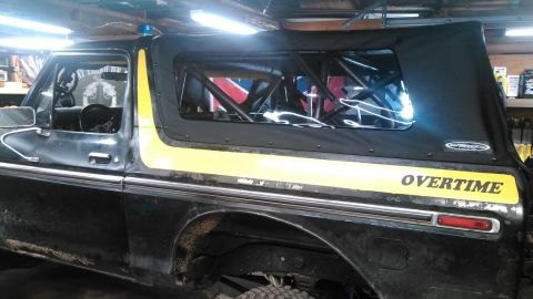 1978 Ford Bronco - This 1978 Ford Bronco features a black soft top with a yellow stripe and "OVERTIME" lettering on the side.