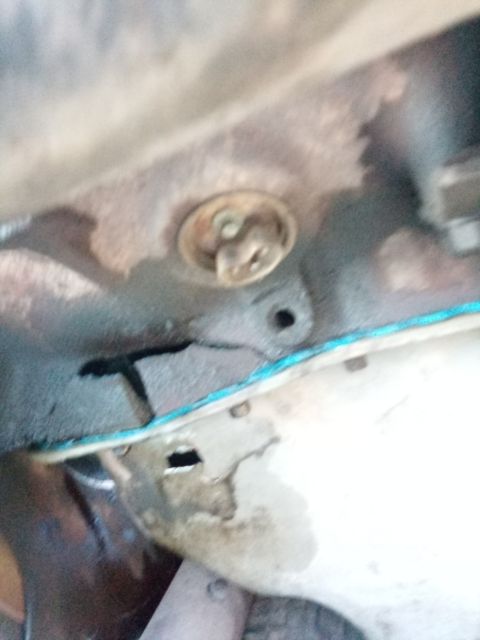 1994 Ford Bronco - A close-up view of an engine component, possibly a thermostat housing, showing some wear and tear.