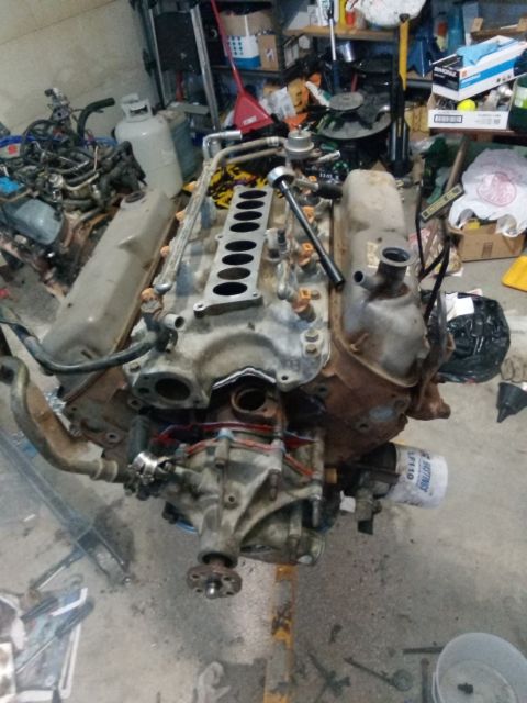 1994 Ford Bronco - Engine assembly with intake manifold removed, showing fuel injectors and oil filter.
