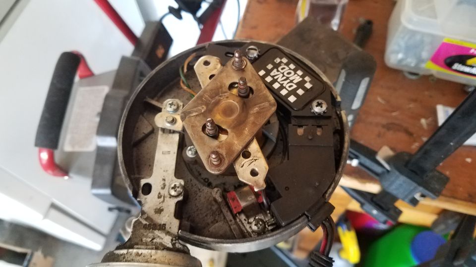 Distributor cap interior with Dyna Mod label, showing metal contacts and wiring