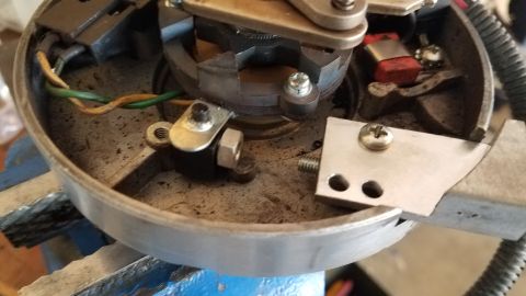 1985 Ford Bronco - The internal components of a vehicle's distributor cap are shown, secured in a vise.
