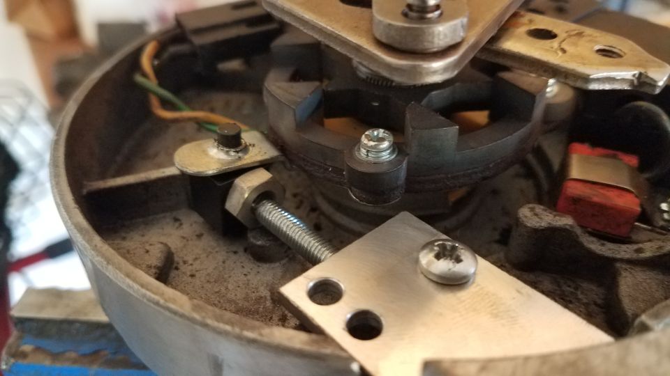 Distributor cap interior with wires and metal components. Supermotors.net logo visible