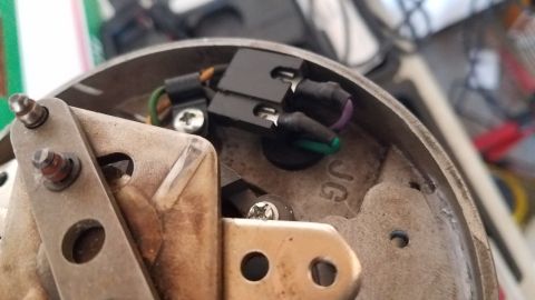 1985 Ford Bronco - Interior view of a distributor cap showing electrical connectors and internal mechanisms.