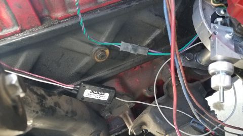 1985 Ford Bronco - Ignition system wiring and electronic module attached to an engine block.