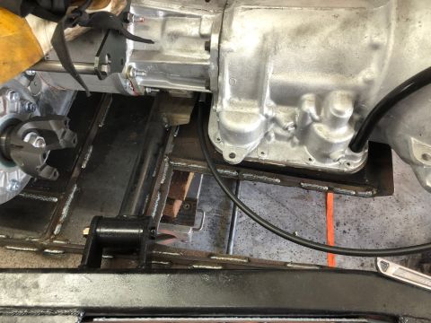 1992 Jeep Wrangler - Transmission and driveshaft parts are visible in this close-up view of a vehicle's undercarriage.