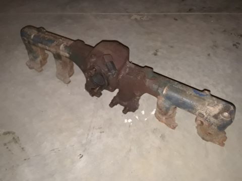 1994 Ford Bronco - This is a close-up of a used exhaust manifold, showing signs of rust and wear.