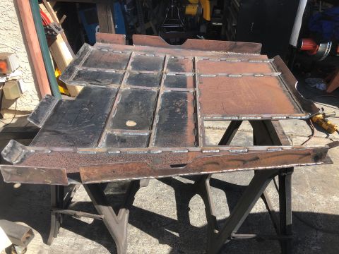 1992 Jeep Wrangler - Newly fabricated and welded metal frame sections are displayed on sawhorses, awaiting installation.