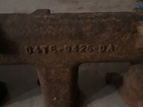 1994 Ford Bronco - Close-up of a cast iron exhaust manifold showing a date stamp.