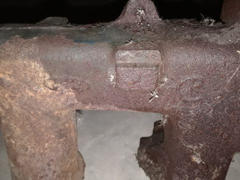 1994 Ford Bronco - This is a close-up view of a heavily rusted metal casting, possibly an engine part.
