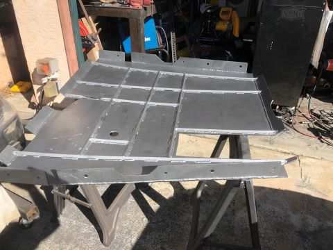 1992 Jeep Wrangler - A fabricated metal frame part, likely for a vehicle, is shown in a workshop setting.