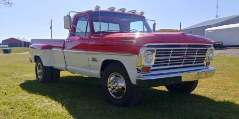 1994 Ford Bronco - This two-tone red and white dually pickup truck presents a classic American truck aesthetic from the early 1970s.