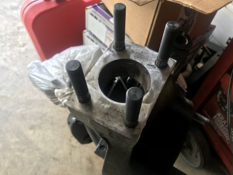 1989 Ford Bronco - Close-up of an engine cylinder block with four threaded studs visible.
