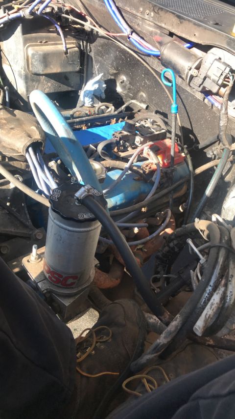 1989 Ford Bronco - Close-up view of an engine bay with various hoses and wires visible.