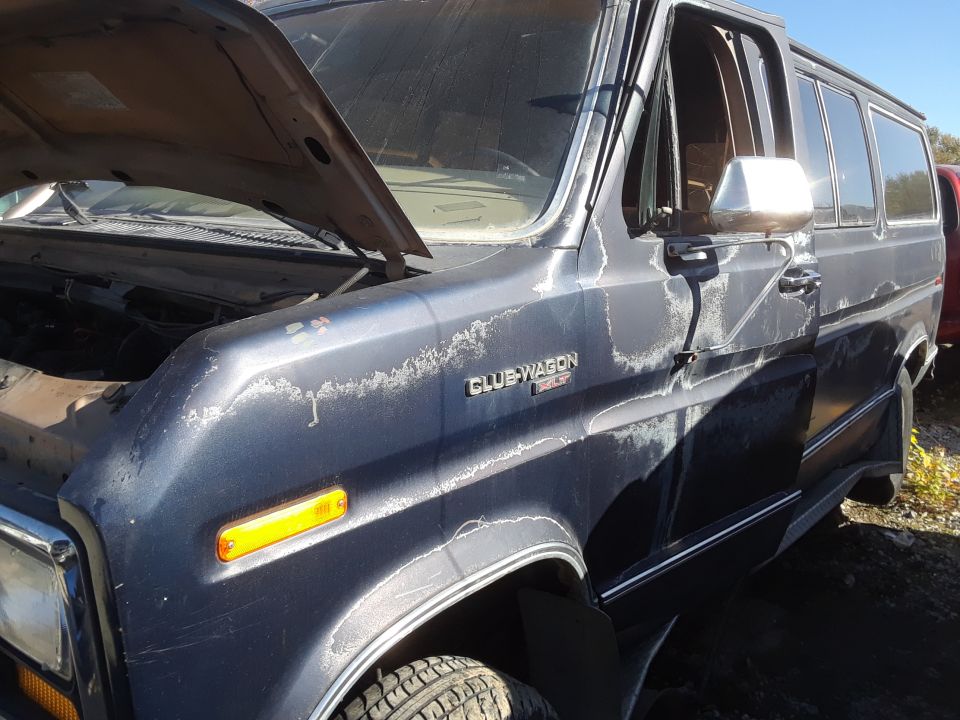 Ford Club Wagon van, hood up, paint peeling, driver's door open