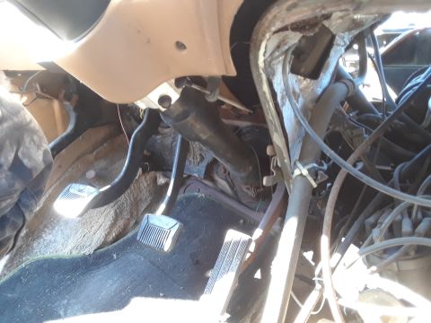 1994 Ford Bronco - The interior of a vehicle shows worn pedals and exposed wiring, with no clear year identification visible.