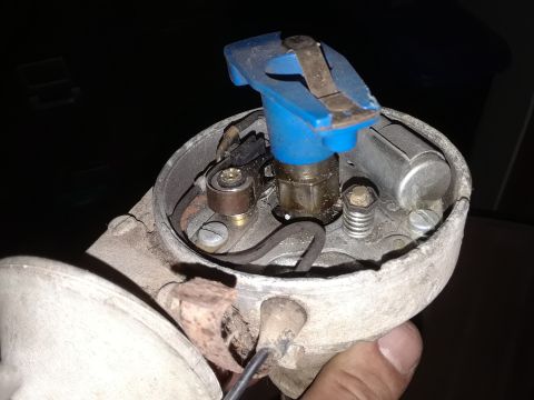 1994 Ford Bronco - This is a close-up view of a vehicle's ignition distributor, showing the cap and rotor components.