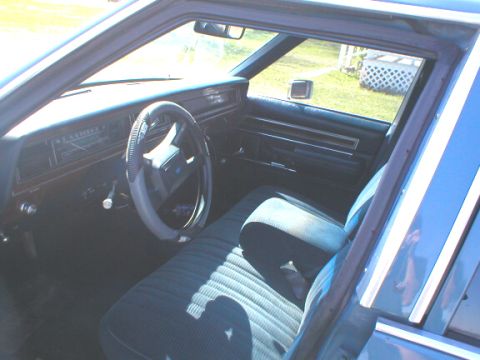 1987 Ford Crown Victoria LTD - Interior view of a 1987 Ford Crown Victoria LTD, showing the front seats and dashboard.