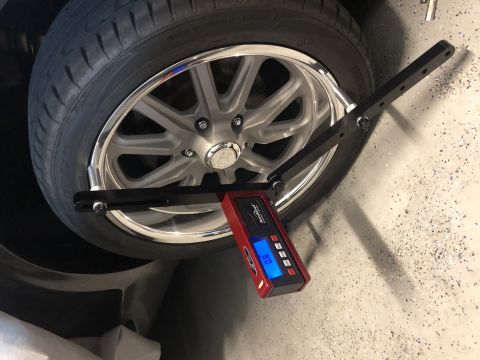 1968 Mercury Cougar - A digital gauge measures alignment settings on a custom car wheel and tire.
