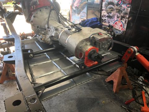 1992 Jeep Wrangler - Transmission and frame assembly shown on jack stands, with various mechanical components visible.