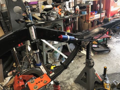1992 Jeep Wrangler - Close-up of a vehicle's frame and suspension system in a workshop setting.