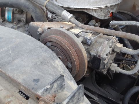 1994 Ford Bronco - Engine bay components, including a compressor clutch and various hoses, are visible in this close-up shot.