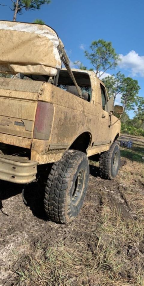 1988 Ford Bronco - This vehicle is covered in mud after driving through a muddy area.
