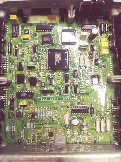 1996 Ford Bronco - This is a close-up view of an engine control unit's internal circuitry, numerous electronic components.