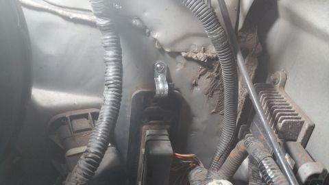 1996 Ford Bronco - Engine bay wiring and mounting hardware are visible in this close-up view.
