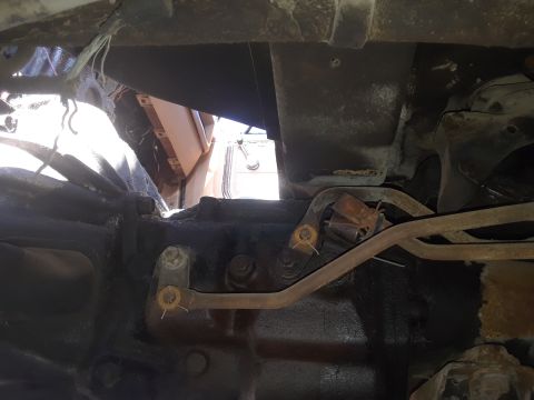 1994 Ford Bronco - A close-up view of the underside of a vehicle, revealing mechanical parts and brake lines.