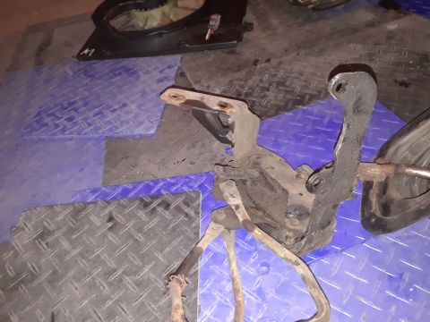 1994 Ford Bronco - A vehicle suspension part is shown on a blue and black diamond plate surface.