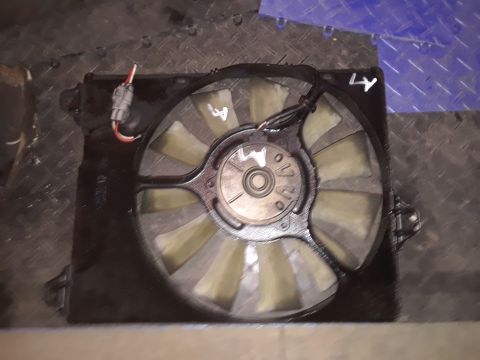 1994 Ford Bronco - A radiator fan assembly is shown, yellow-tinted blades and a black shroud, likely a replacement part.