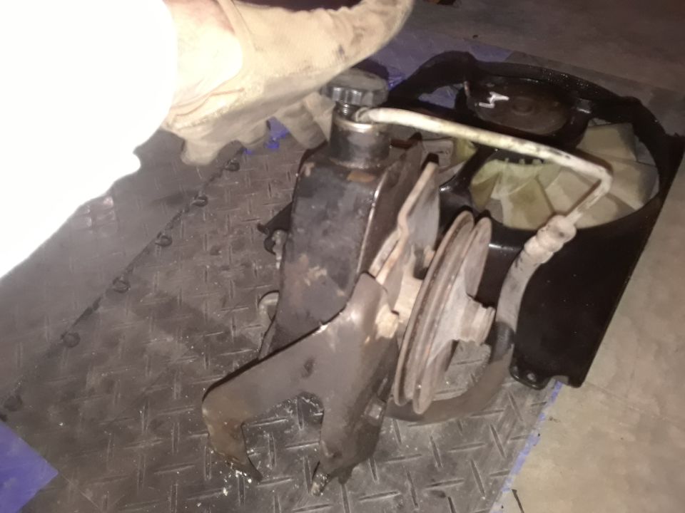Power steering pump with pulley and fan shroud removed from engine bay
