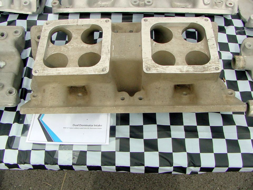 Dual quad intake manifold on checkered cloth. Paper label says "Dual Dominator Intake"