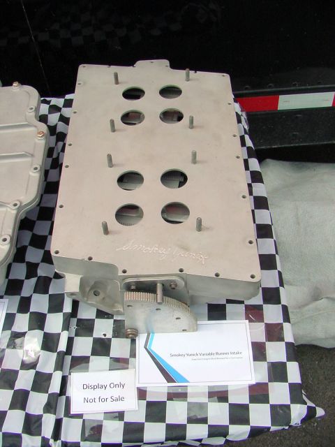 1969 Ford Mustang - Smokey Yunick Variable Runner Intake displayed on a table with a checkered cloth.