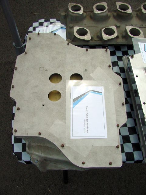 1969 Ford Mustang - A Smokey Yunick Boss Ram Intake part is displayed on a table with a checkered cloth.