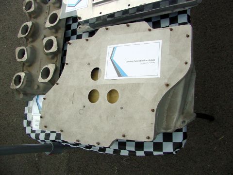 1969 Ford Mustang - Close-up of an engine intake manifold, identified as a "Smokey Yunick Box Ram Intake" part.