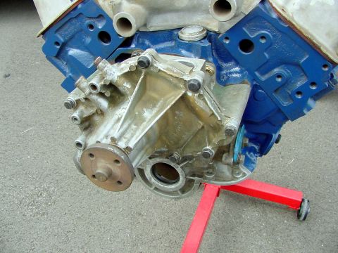 1969 Ford Mustang - Close-up view of an engine block and water pump assembly, blue painted components and a metal stand.
