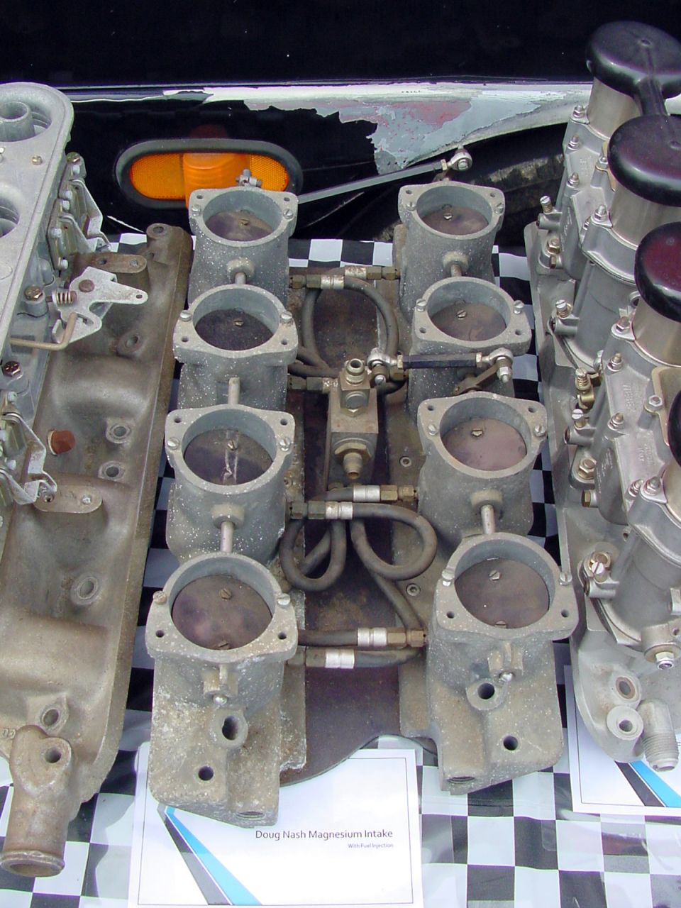 Dual quad intake manifold with carburetors, labeled 'Doug Nash Magnesium Intake'