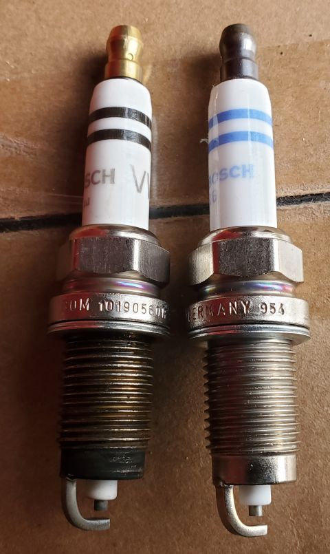2000 Ford Crown Victoria - Two Bosch spark plugs are shown side-by-side, with visible branding and manufacturing details.