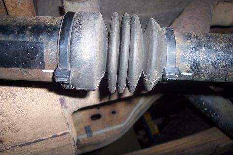 1995 Ford Bronco - A driveshaft boot is secured with zip ties, showing a part of a vehicle's undercarriage.