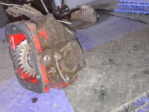 1994 Ford Bronco - Differential housing with exposed gears sits on a diamond plate floor.