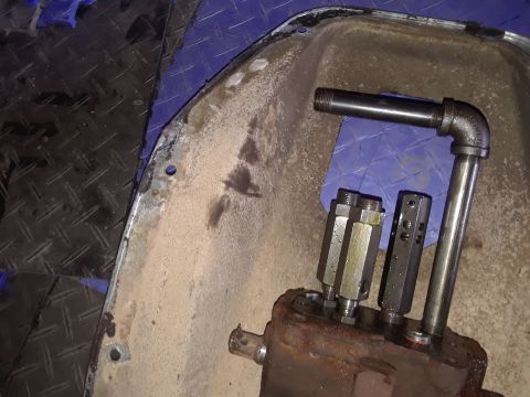 1994 Ford Bronco - Close-up of an automotive part with attached plumbing fittings and pipes.