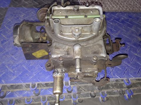 1994 Ford Bronco - A used carburetor is shown, likely from an older vehicle, with a visible yellow sticker and website logo.
