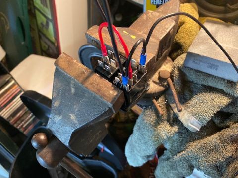 1996 Ford Bronco - Automotive relays are being worked on while secured in a vise.