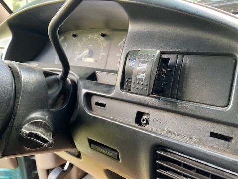 1996 Ford Bronco - Close-up of the dashboard showing the steering column, instrument cluster, and auxiliary switches.