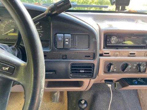 1996 Ford Bronco - Interior view of a 1996 Ford Bronco, showing the dashboard with a Pioneer stereo and overdrive lever.