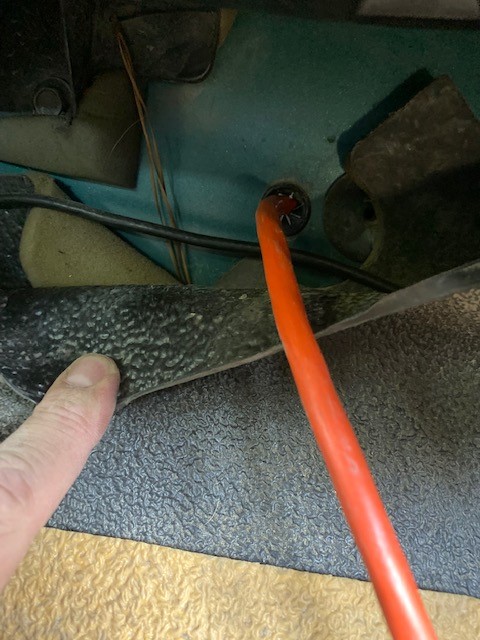 1996 Ford Bronco - Interior view showing wiring and an orange cable routed through a grommet.