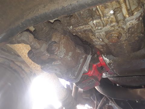 1994 Ford Bronco - Close-up of a heavily soiled vehicle component, showing signs of wear and tear.