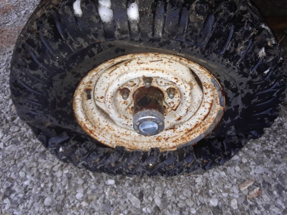 Rusty wheel and tire on gravel